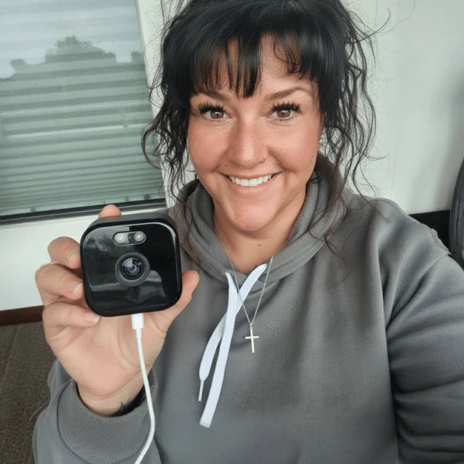 Customer holding a FrontlineCam camera